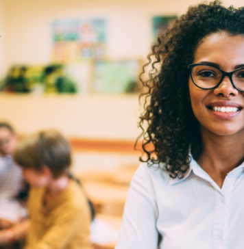 How to Show Your Child’s Teachers They are Appreciated teacher stands in front of students who are seated and working