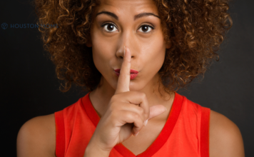 woman holding finger to her mouth indicating quiet