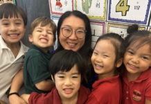 preschool teacher surrounded by her students