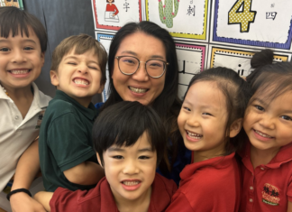 preschool teacher surrounded by her students