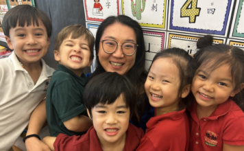 preschool teacher surrounded by her students
