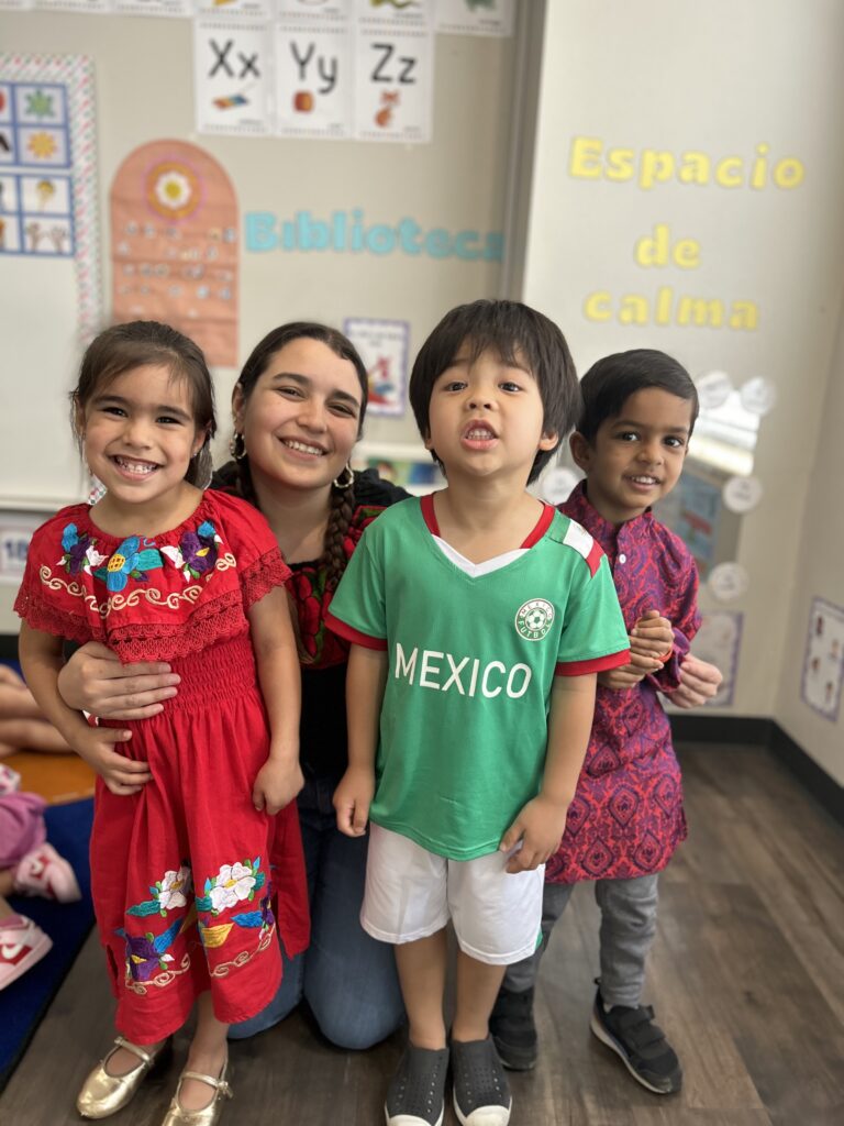 A preschool teacher with a group of students