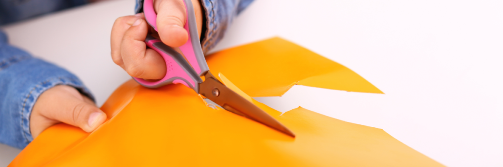 Stuck image of child cutting construction paper